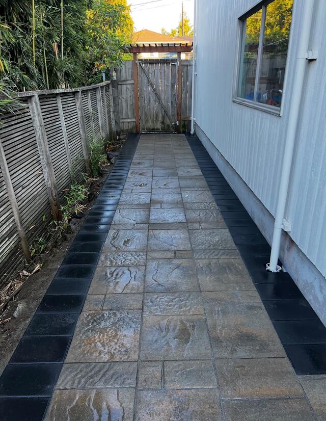 Dark paver walkway with a rich wet finish