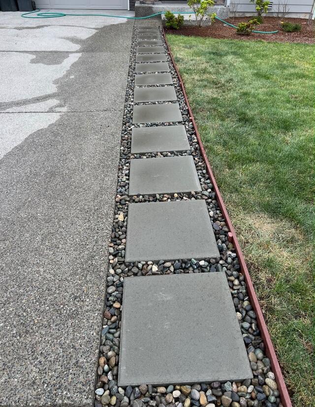 Concrete stepping pads with a river rock border